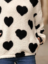 Fuzzy heart pocketed dropped shoulder hoodie in white and black heart pattern