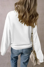 Woman in game day football long sleeve sweatshirt and jeans with bag