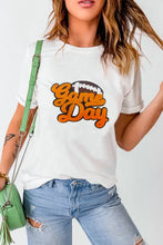 Game Day Graphic White T-Shirt with Distressed Jeans and Green Bag