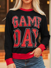 Black game day baggy sweatshirt with red lettering and trim, slightly stretchy, machine wash cold recommended
