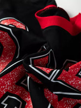 Black and red game day varsity striped baggy sweatshirt with bold white trim numerals and slightly stretchy speckled fabric machine wash cold
