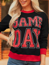 Black slightly stretchy game day sweatshirt with red glittery lettering and matching red trim, machine wash cold