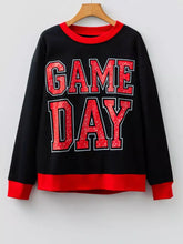 Black and red game day sweatshirt with glittery lettering, contrasting ribbed cuffs, slightly stretchy, machine wash cold