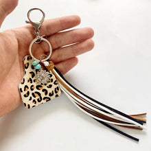 Genuine leather key chain with sunflower charm, turquoise fringe, and leopard print tassel