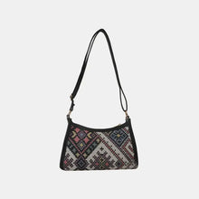 Printed crossbody bag with black strap and embroidered pattern