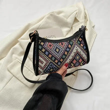 Printed crossbody bag with colorful geometric embroidery and black trim