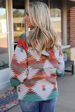 Woman in colorful tribal Geometric Half-Zip Drawstring Hoodie with long sleeves and blue jeans