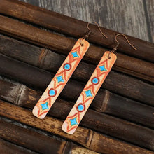 Light brown leather bar earrings with turquoise and orange geometric patterns