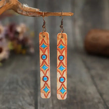 Geometric leather bar earrings with blue diamond and circle pattern