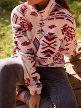 A cozy cream-colored fleece sweatshirt with a half-zip and bold red and blue geometric patterns machine wash cold