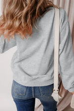 Ghost Round Neck Long Sleeve Sweatshirt in light gray with blue jeans and cream bag