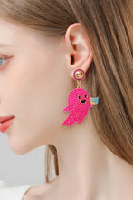 Woman wearing sparkly pink zinc alloy ghost shape synthetic pearl dangle earring