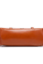 Tan leather clutch handbag with silver hardware and red lining