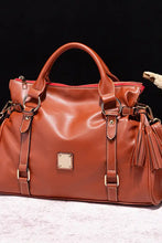 Brown PU leather handbag with red lining and tassels