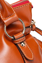 Glossy tan leather handbag with red zipper, lining, gold hardware, and tassel detailing