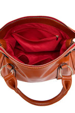 Glossy brown leather handbag with red lining and silver hardware