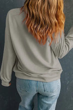 Woman in gray top and blue jeans wearing Gobble Gobble graphic round neck long sleeve sweatshirt