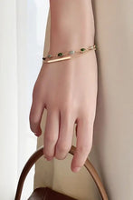 Slender gold alloy double-layered bracelet with bar charm and green-grey beads