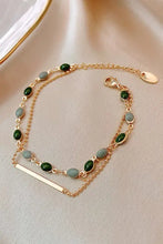 Gold alloy double-layered bracelet with green beads and rectangular bar accent