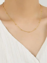 Delicate gold-toned sterling silver beaded necklace with chain length of small spheres