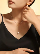 Woman in gold bow pendant necklace with pearl drop on stainless steel chain