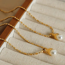 Two titanium steel pearl pendant necklaces with gold chains
