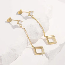 Pair of gold dangle earrings with inlaid zircon and rhombus drops