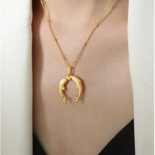 Gold horseshoe jewelry set with double dolphin pendant necklace