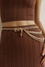 Gold metal chain belt with rhinestone decor and padlock charm on skirt