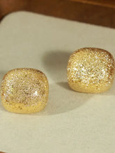 Two gold-plated geometric stud earrings with golden glitter