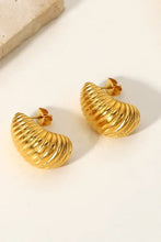 Pair of ridged golden shore spiral stud earrings in textured hoop design