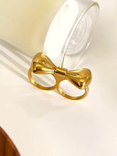 Shiny gold-plated stainless steel bow ring with intricate two-finger design