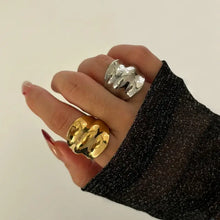 Hand with gold-plated stainless steel wrinkled wide band ring