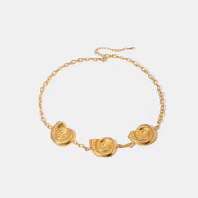 Gold spiral charm necklace with three snail shell pendants