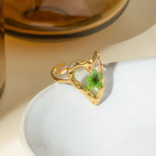 Gold stainless steel eternal flower ring with green pressed heart