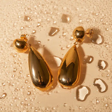 Gold stainless steel teardrop dangle earrings with black accents
