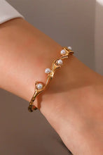 Gold tone cuff pearl open bracelet with inlaid synthetic pearls