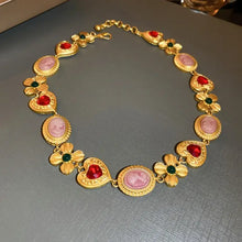 Gold toned copper inlaid rhinestone necklace with heart red gems, floral green gems, and pink cameos