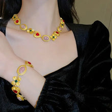 Gold toned copper inlaid rhinestone necklace and bracelet set with gemstone accents