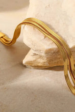 Gold triple-layered snake chain bracelet with braided cord texture
