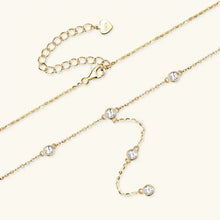 Gold Y-shaped necklace with bezel-set cubic zirconia, sterling silver chain