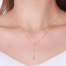Elegant gold Y-shaped necklace with diamond initial pendant and bezel-set cubic zirconia stations