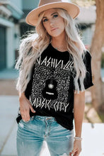 Woman in Nashville Music City graphic cuffed sleeve round neck tee