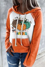 Orange and white graphic drawstring long sleeve hoodie with pumpkin design