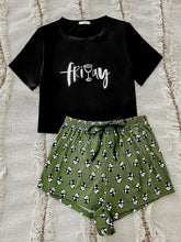 Black short-sleeved graphic tee with white friday print and olive green panda print shorts lounge set with sleeve length detail