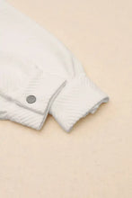 White quilted jacket with silver buttons and sleeve length options