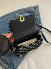 Gray checkered denim crossbody bag with gold clasp and frayed edges