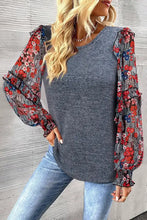 Gray floral print puff sleeve sweater with red and blue accents
