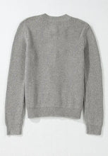 Heather gray crew neck sweater with ribbed texture, long sleeves, cuffs, and buttons