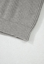 Light gray ribbed knit sweater with folded hem and lace-up details